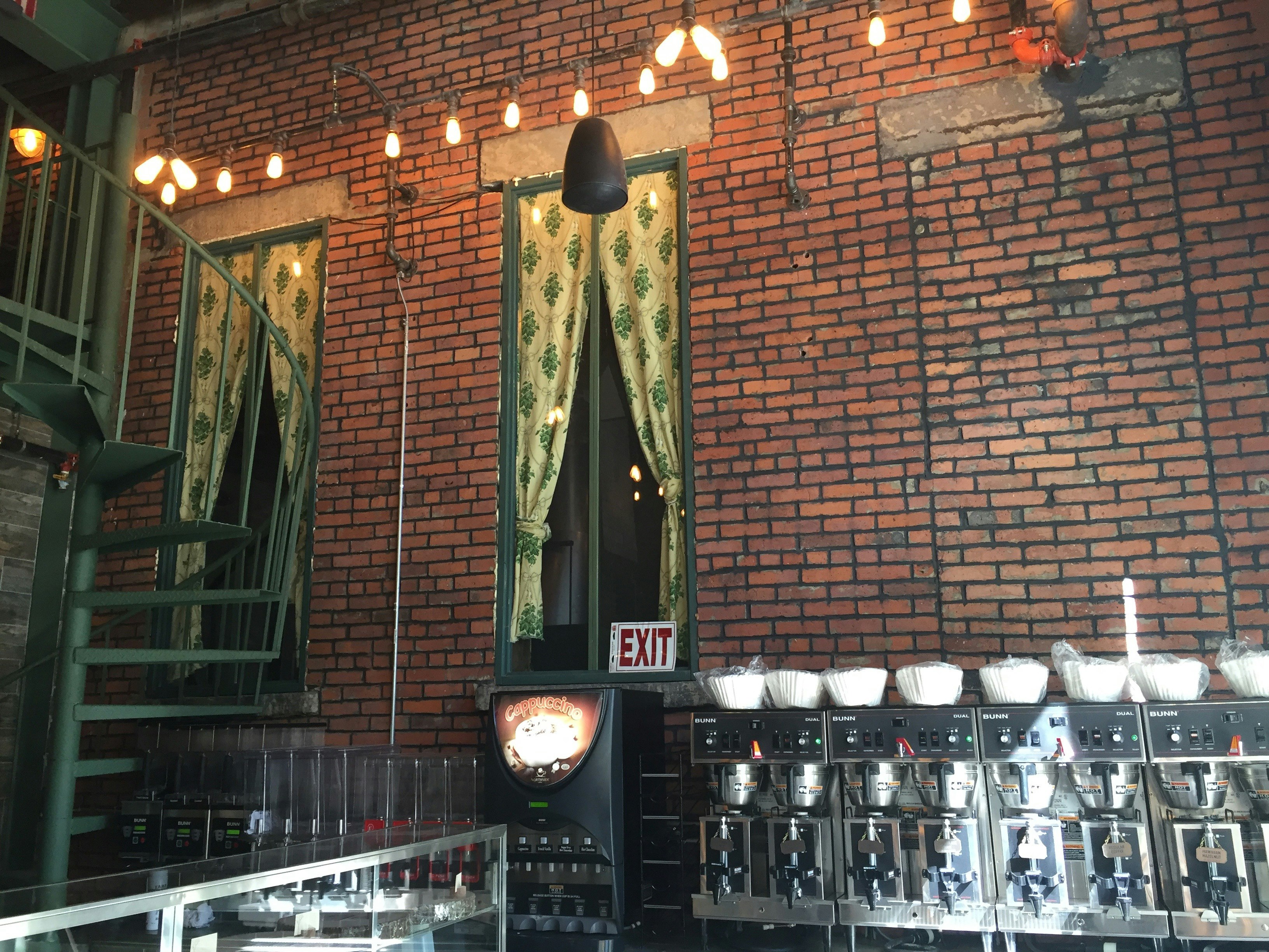 brown brick wall with exit signage